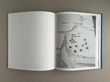 Open spread of Sub Sole by Massao Mascaro, with a black-and-white photograph on the right page and a blank left page.