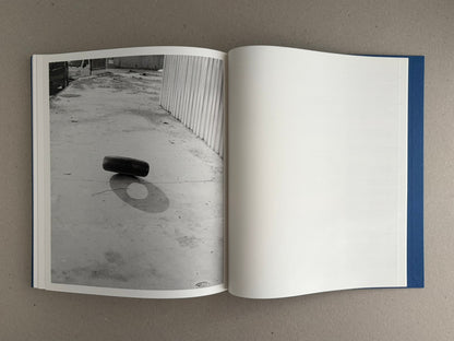 Open spread of Sub Sole by Massao Mascaro, showing a black-and-white photograph on the left page and a blank right page.