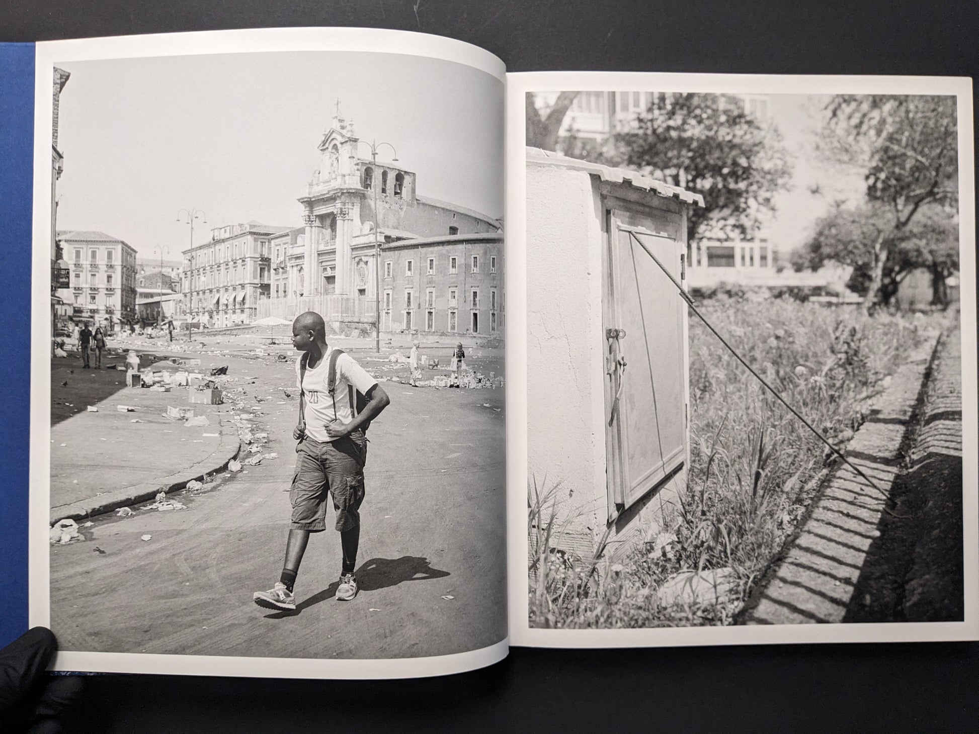 Photobook spread pairing a street scene with a walking figure and a wall casting a long shadow.
