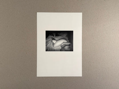 Surveillance – Tsutomu Yamagata, printed page with a small black-and-white photograph of a reclining nude figure on a bed.