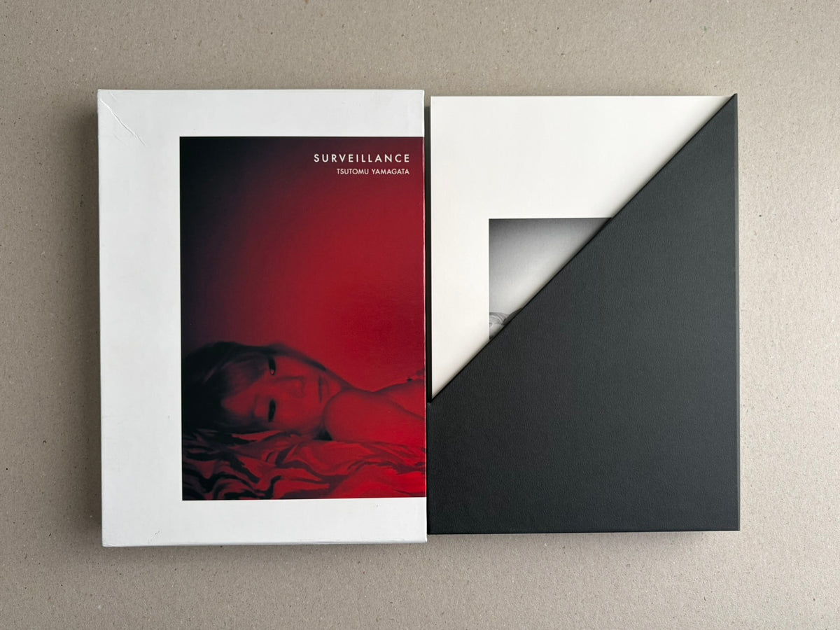 Surveillance – Tsutomu Yamagata, shown with the printed cover and a black-and-white slipcase.
