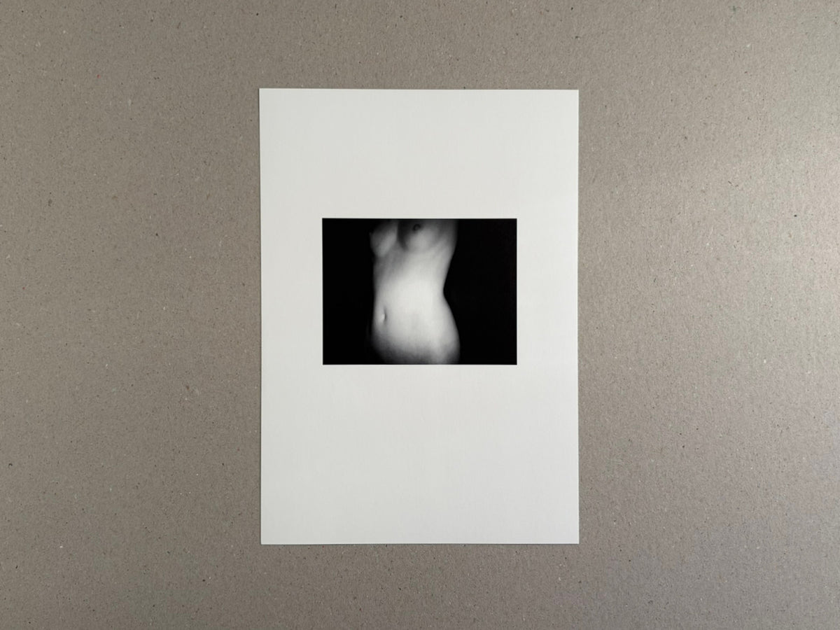 Surveillance – Tsutomu Yamagata, book cover with a small black-and-white nude torso photograph centered on a white cover.