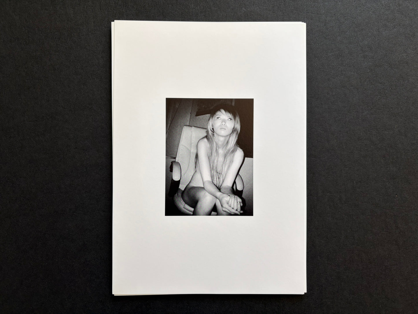 Loose photographic plate from Surveillance showing an infrared portrait of a woman seated in a chair.