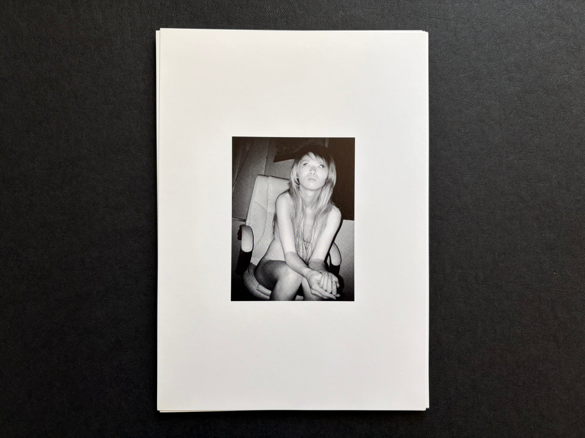 Loose photographic plate from Surveillance showing an infrared portrait of a woman seated in a chair.