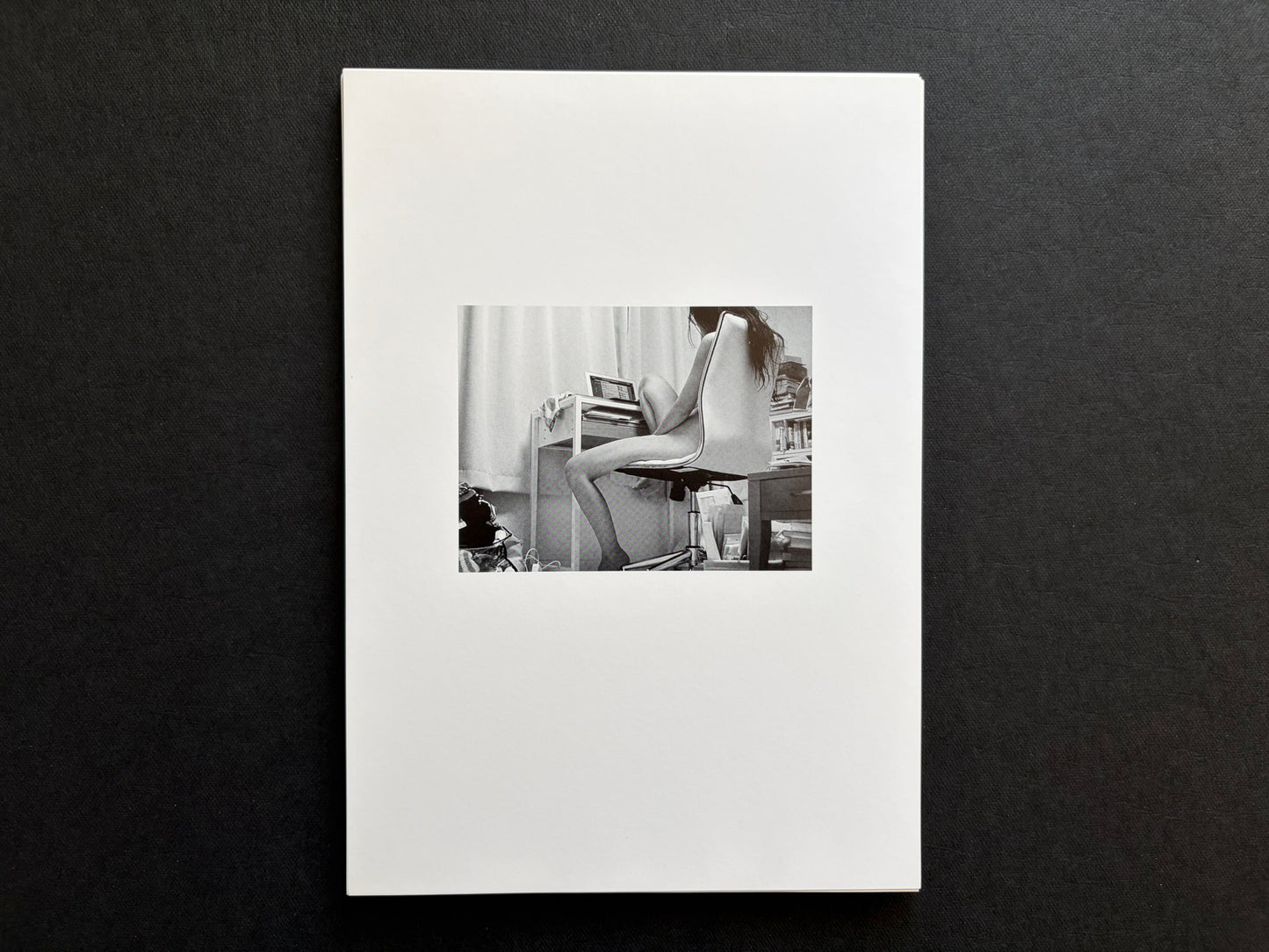 Loose photographic plate from Surveillance showing an infrared interior scene with a figure seated at a desk.