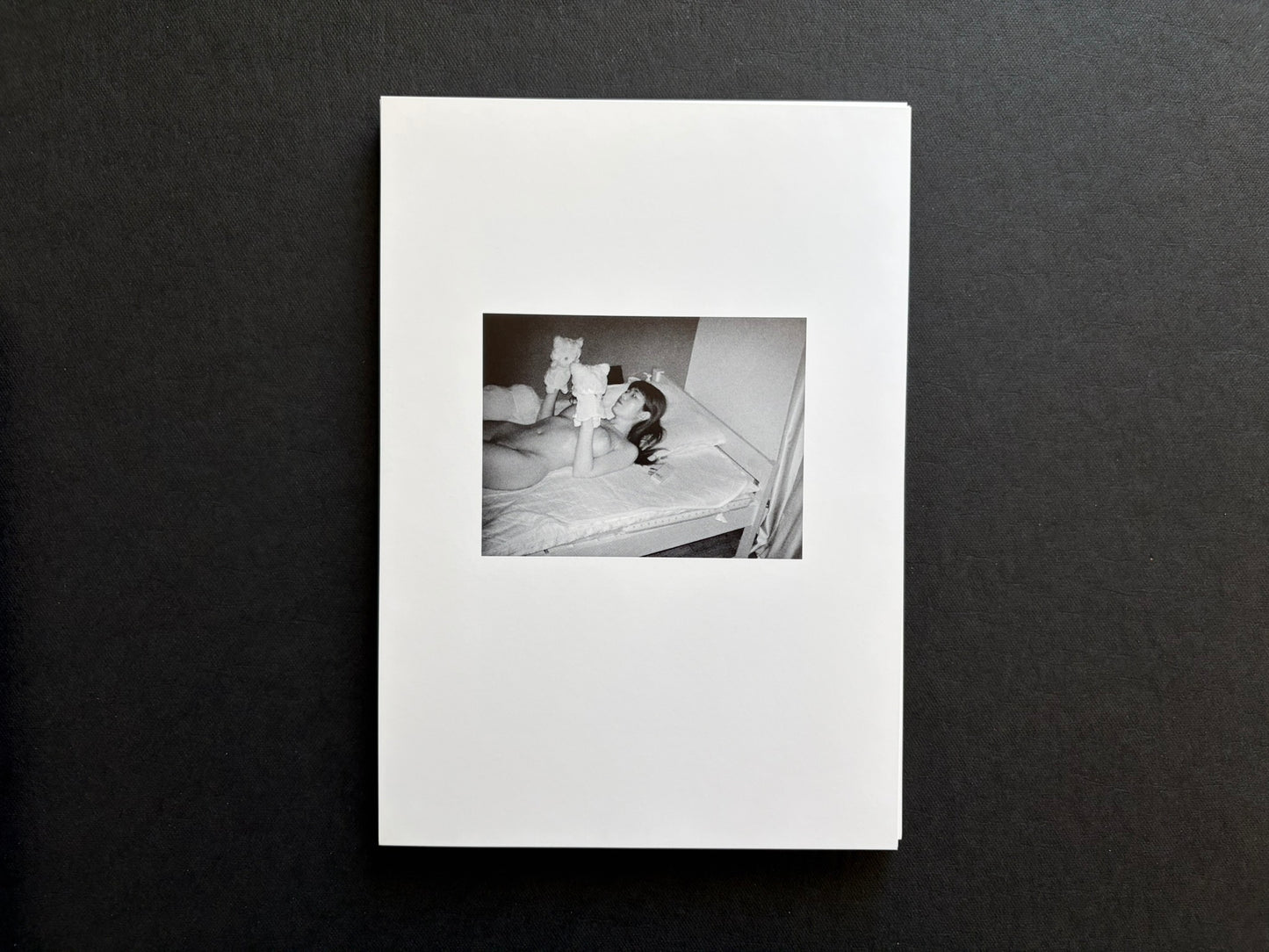 Loose photographic plate from Surveillance showing an infrared image of a resting figure on a bed.