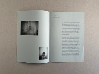 Open spread of Surveillance by Tsutomu Yamagata, showing two black-and-white photographs on the left page and a text page on the right.