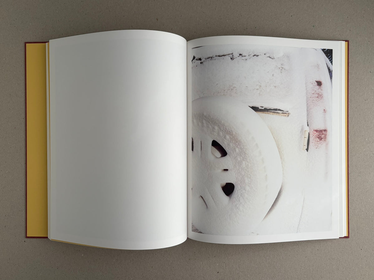 Open copy of süü – Taemin Ha showing a blank left page and a right-hand page with a close-up photograph of a snow-covered surface.