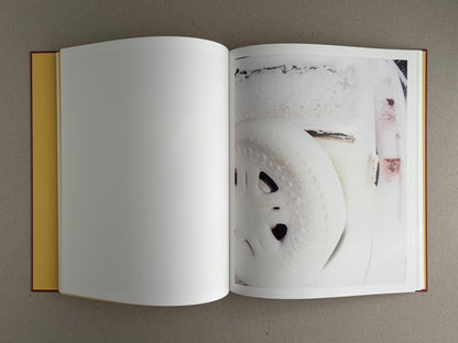 Open copy of süü – Taemin Ha showing a blank left page and a right-hand page with a close-up photograph of a snow-covered surface.