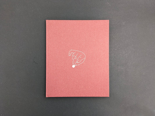 Back cover of süü by Taemin Ha, featuring a minimal line drawing of a hand holding a small dot on a muted red background.