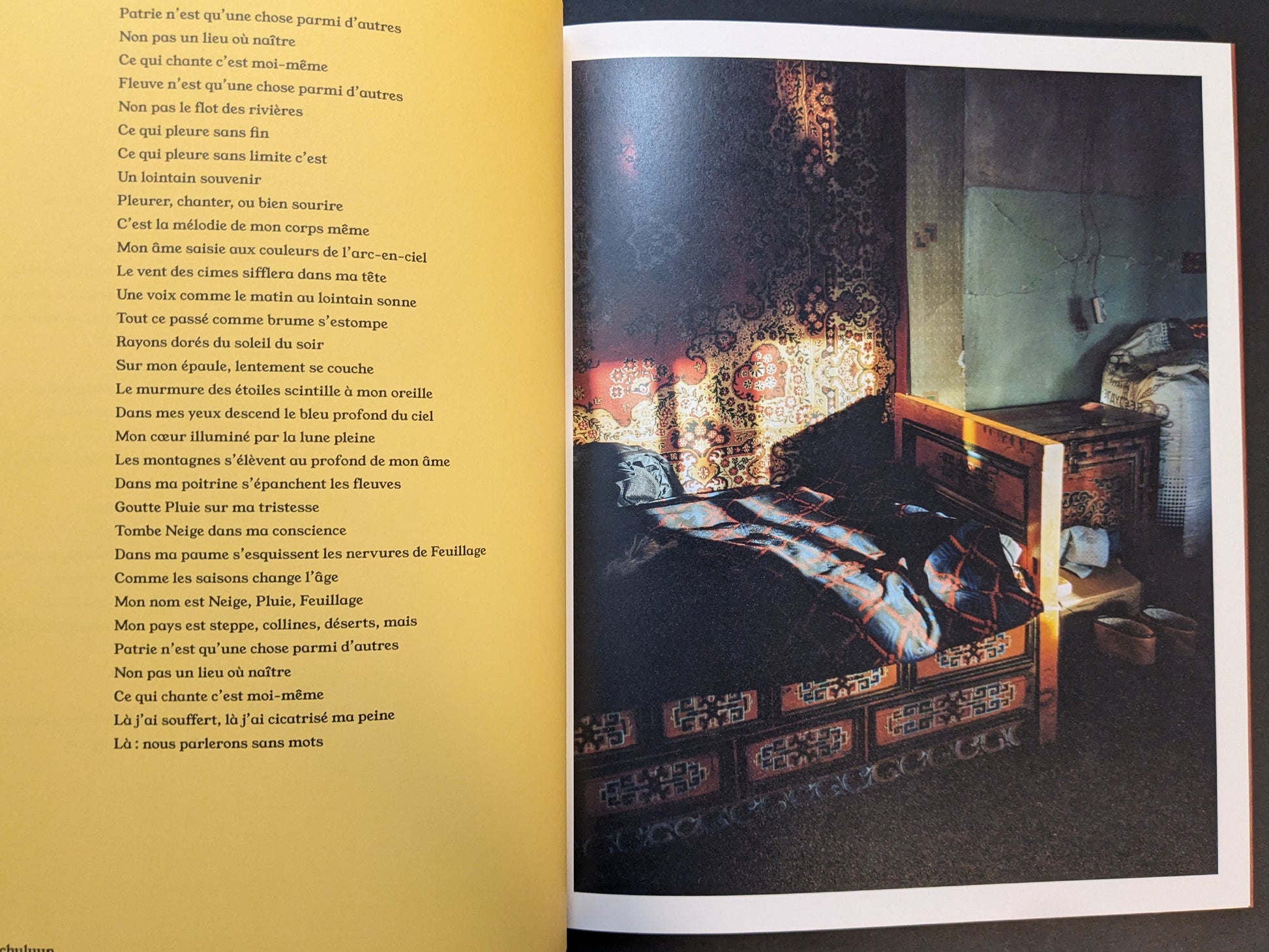 Photobook spread from süü by Taemin Ha pairing a poem page with a quiet interior scene where sunlight falls across a bed and patterned wall.