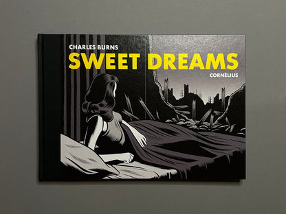 Sweet Dreams by Charles Burns, front cover with a woman in bed and a ruined cityscape behind her.
