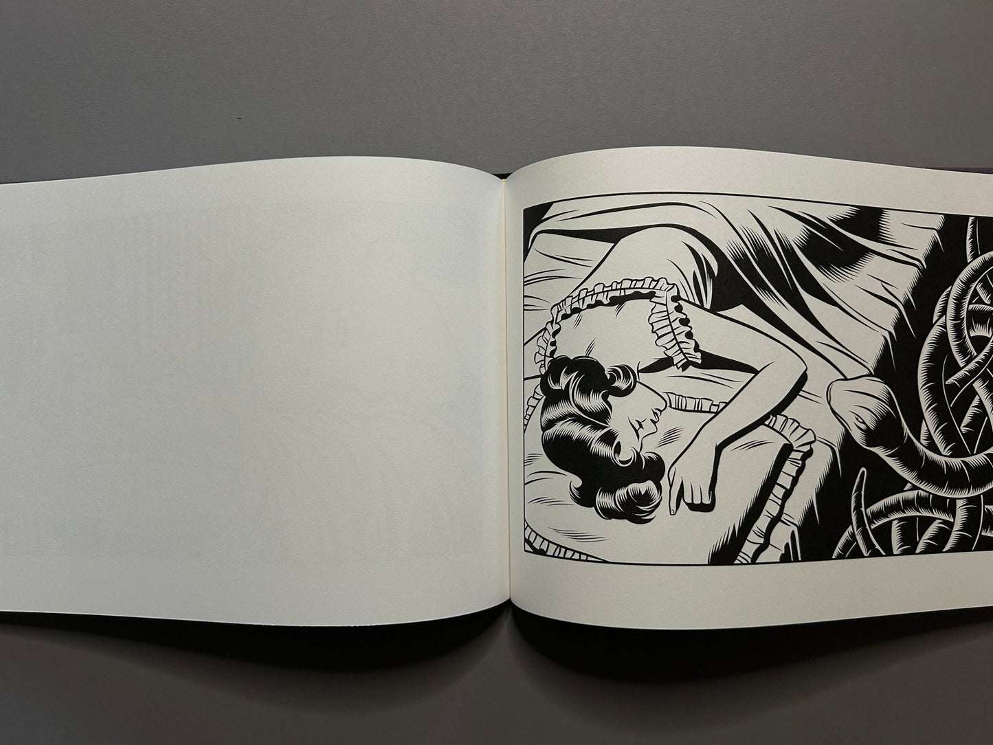 Sweet Dreams open across two pages, showing a sleeping woman in a ruffled bed and a dark, tangled form at the right edge.