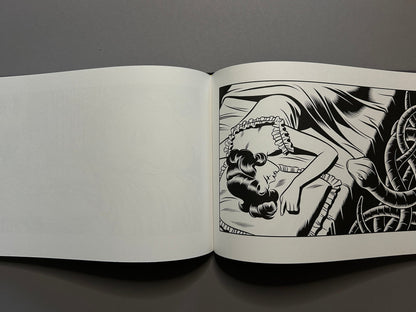 Sweet Dreams open across two pages, showing a sleeping woman in a ruffled bed and a dark, tangled form at the right edge.