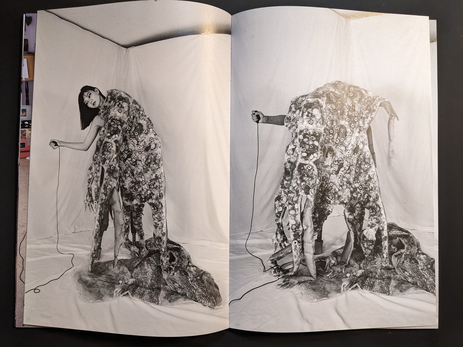 Photographic spread of a hand-sculpture costume with red shoes and prosthetic limbs