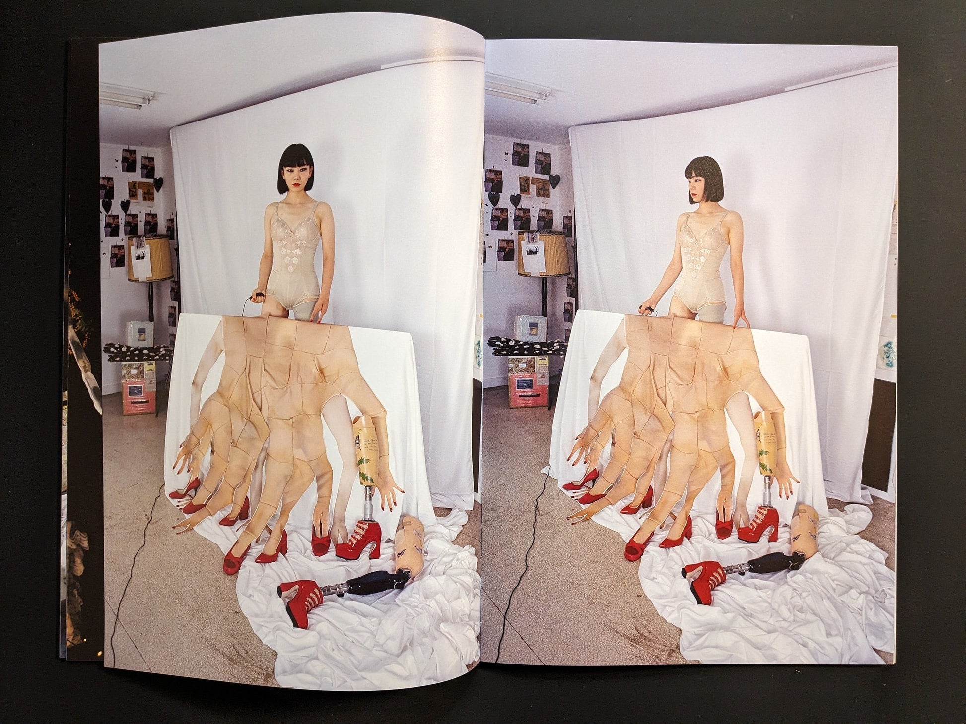 Mari Katayama seated in her studio with mannequins and prosthetic sculptures