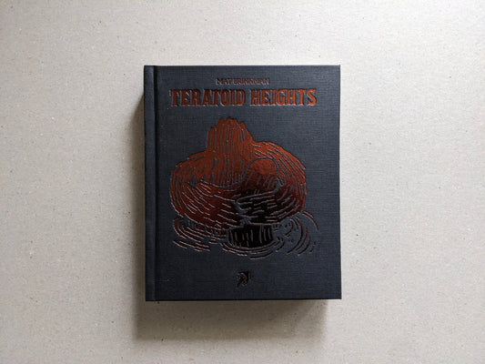Front cover of Teratoid Heights by Mat Brinkman, black canvas hardcover with bronze foil embossing