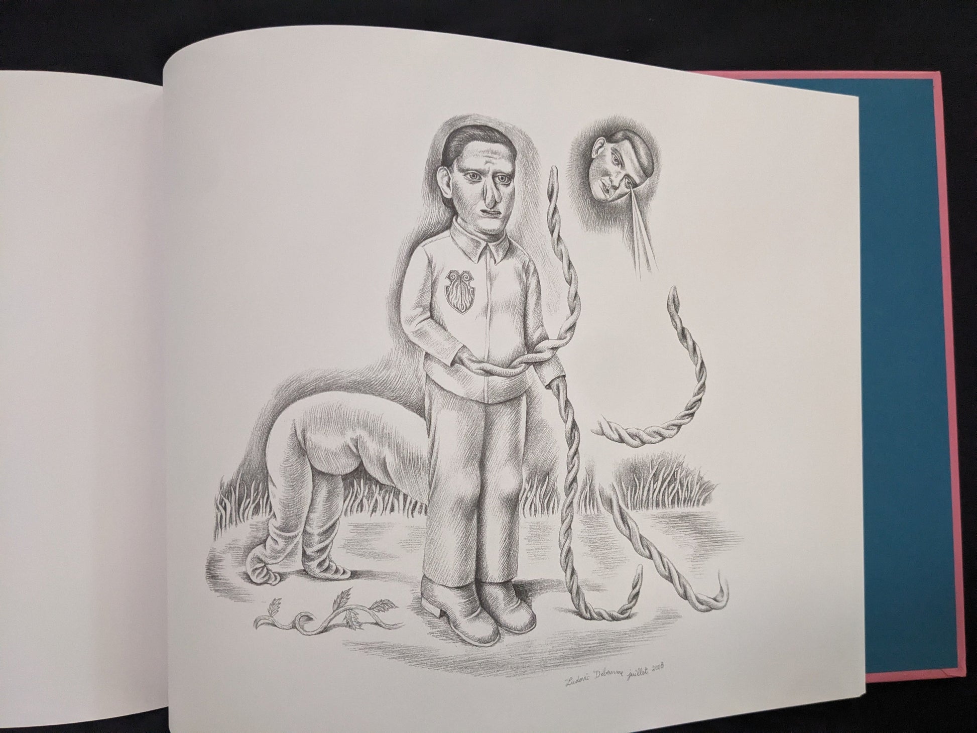 Open Terra Maxima spread with several grotesque pencil figures and a floating head
