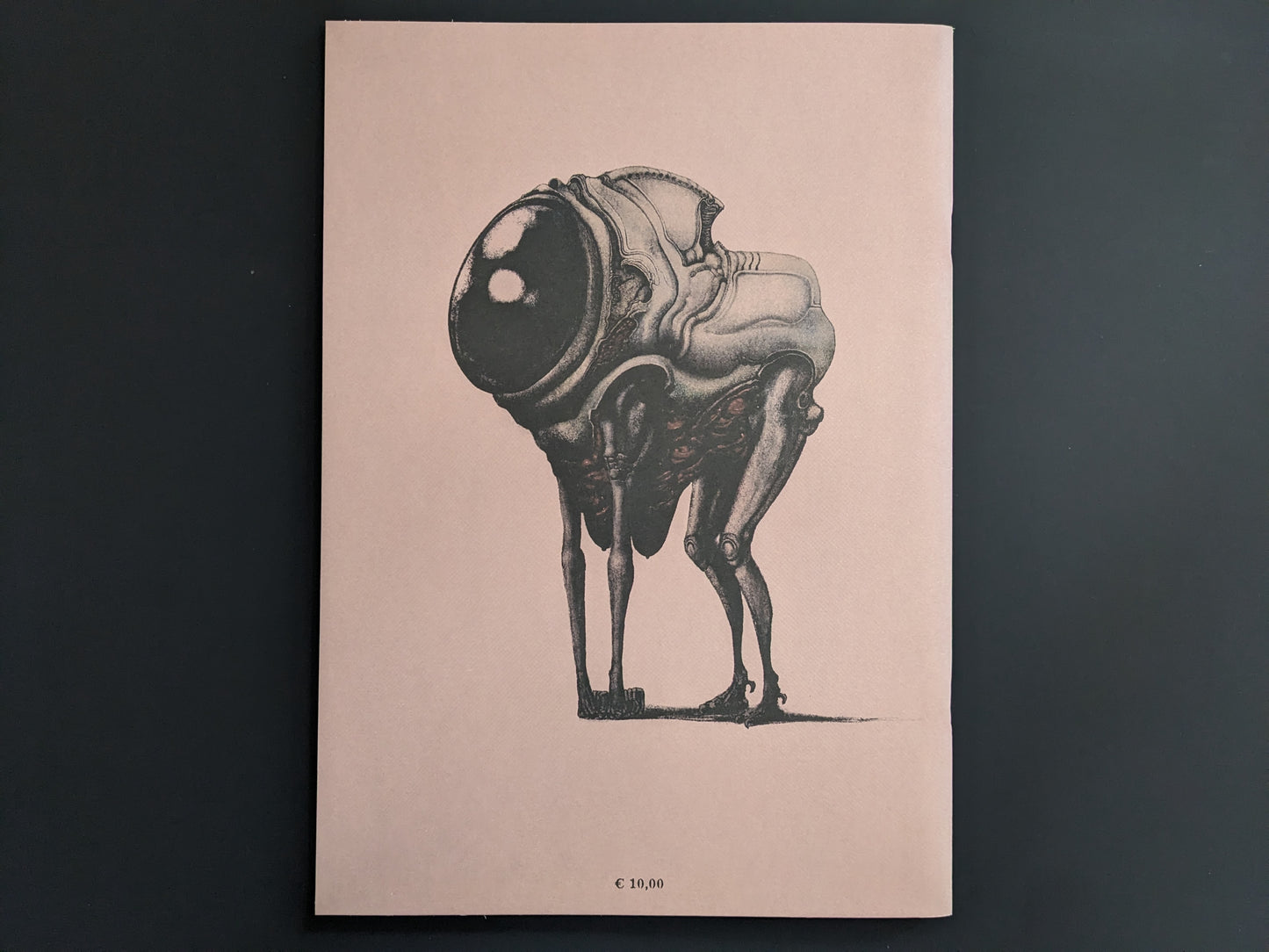 Back cover of Terrotic by Bartosz Zaskòrski, with a biomechanical mutant creature on a pinkish background