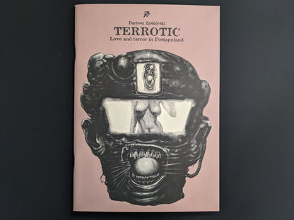 Front cover of Terrotic by Bartosz Zaskòrski – surreal robotic face with reflective visor on muted pink background