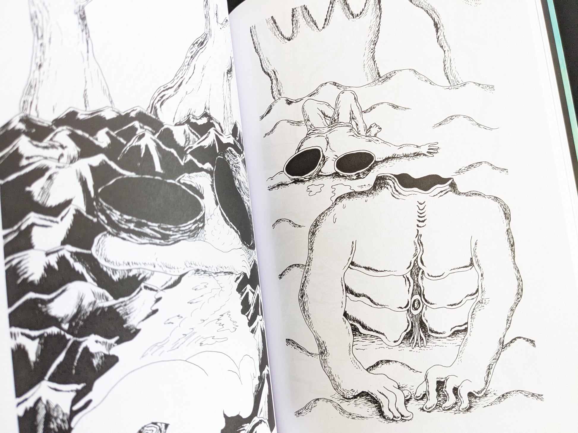 Black-and-white drawing of muscular, headless humanoid bodies with empty eye sockets and sci-fi anatomical details.