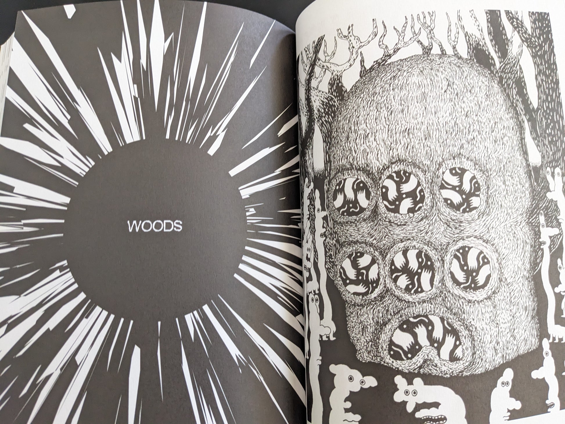Comic page titled “Woods” featuring a large forest-dwelling creature with multiple round eyes and surrounded by smaller figures.