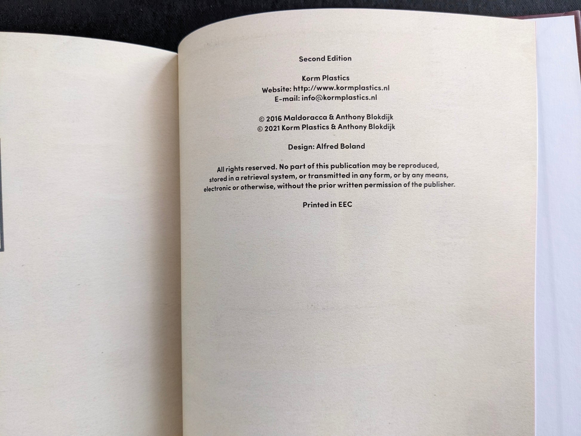 Colophon page listing Korm Plastics, design credit, and second edition publication details.