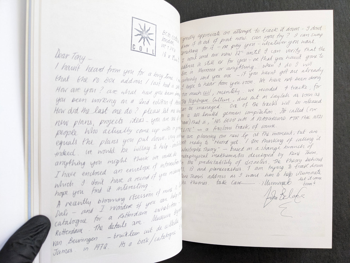 Interior spread with a handwritten John Balance letter across two pages and Coil stationery marks.