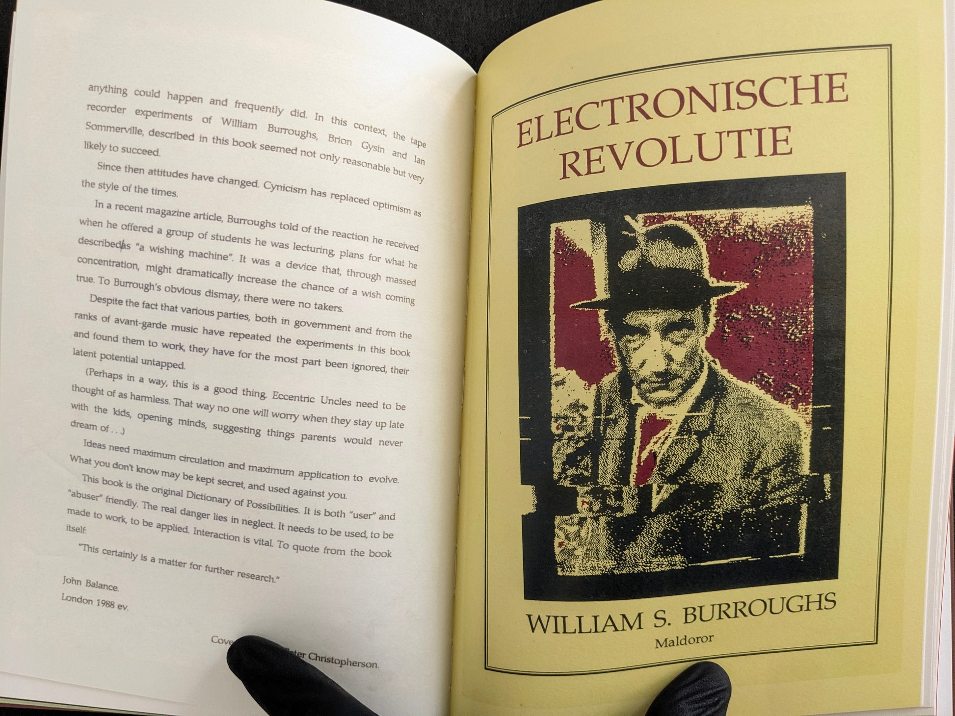Interior spread with English essay text on the left page and an Electronische Revolutie William S. Burroughs poster reproduction on the right.