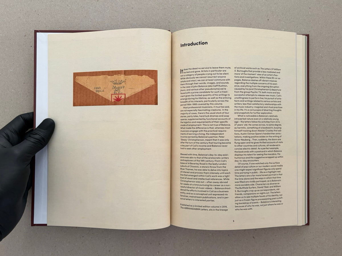 Open book spread from The Abrahadabra Letters – John Balance & Anthony Blokdijk, showing an introduction page with a reproduced letter image on the left and text on the right.
