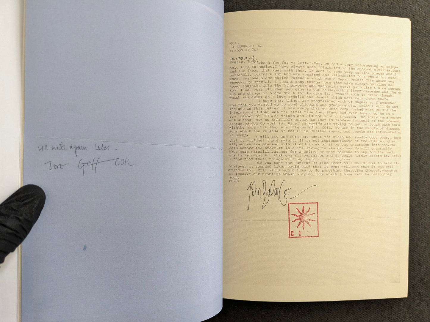 Interior spread with a typed John Balance letter on the right page, signed with the COIL stamp, and a pencilled note on the left page.