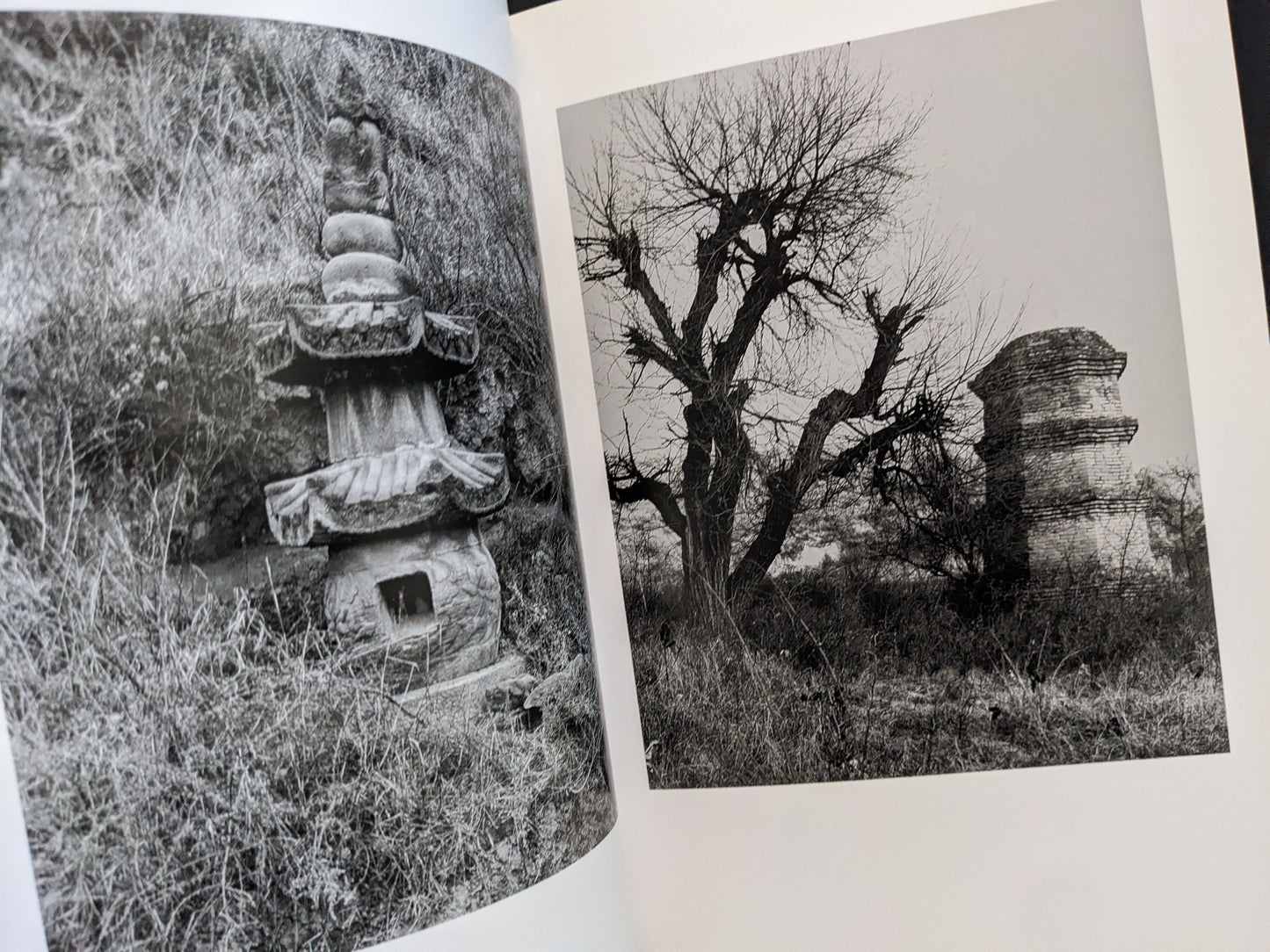 Interior spread with two black-and-white photographs of Buddhist towers in natural surroundings.
