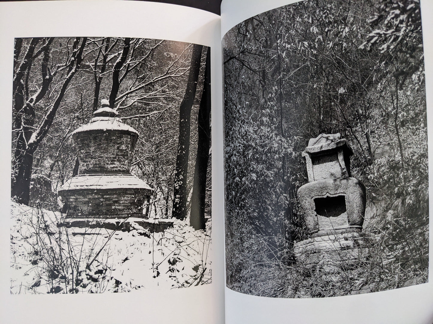 Black-and-white photographs of Buddhist stone towers surrounded by winter trees.