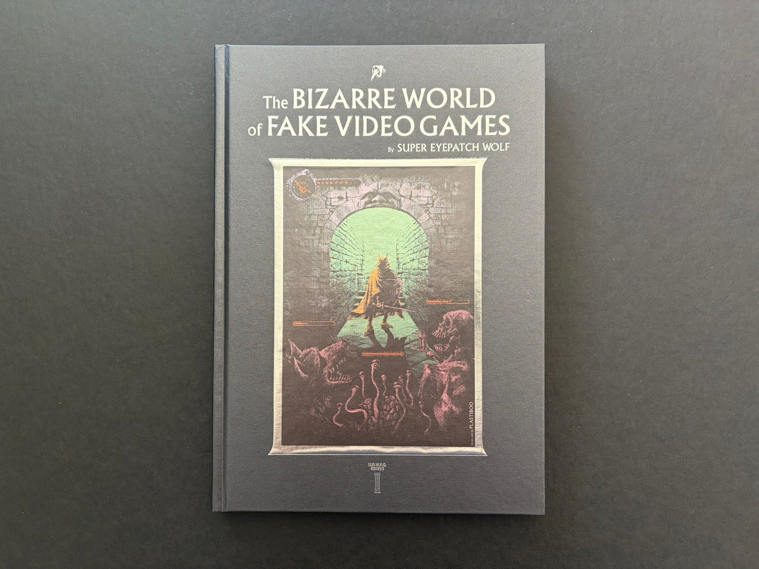 Front cover of The Bizarre World of Fake Video Games by Super Eyepatch Wolf, with dungeon artwork framed in metallic foil.