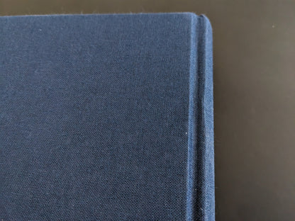 Cloth spine joint of the book with visible signs of use
