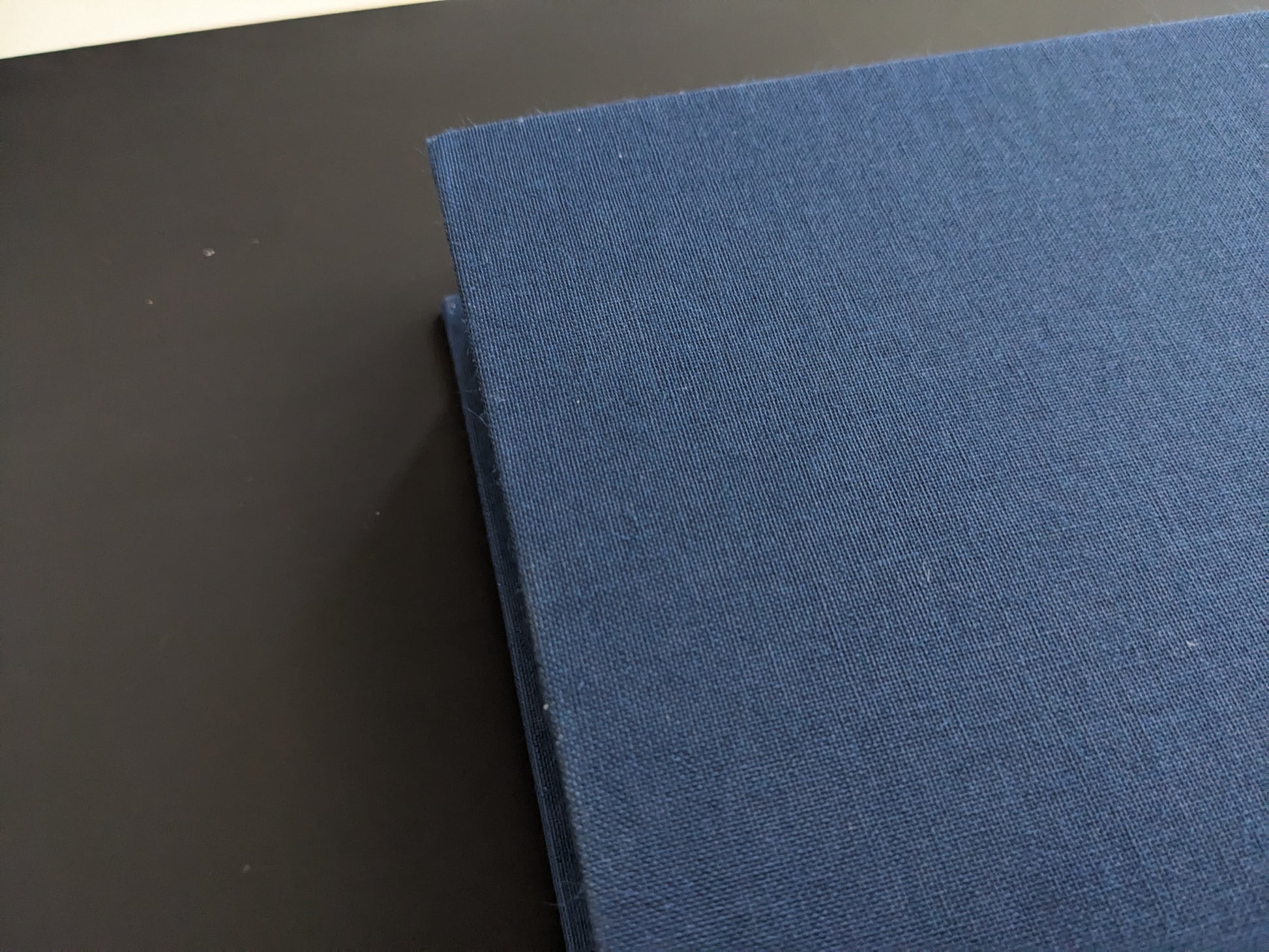 Cloth book spine with noticeable wear marks
