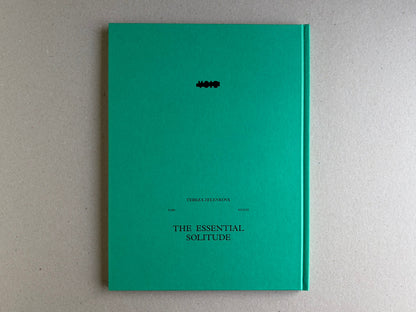 The Essential Solitude back cover on a turquoise hardcover with title and author text.