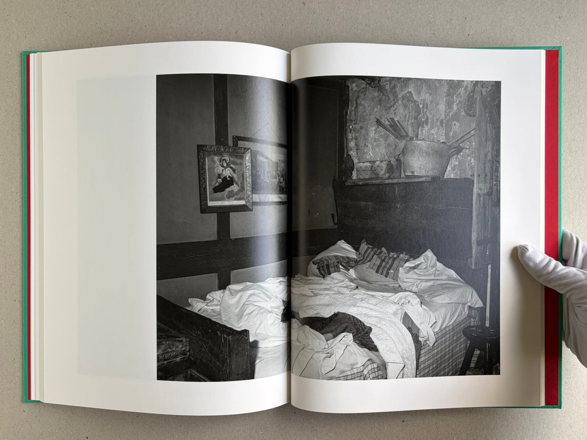 Open spread from The Essential Solitude, showing a black-and-white bed scene on the right page.