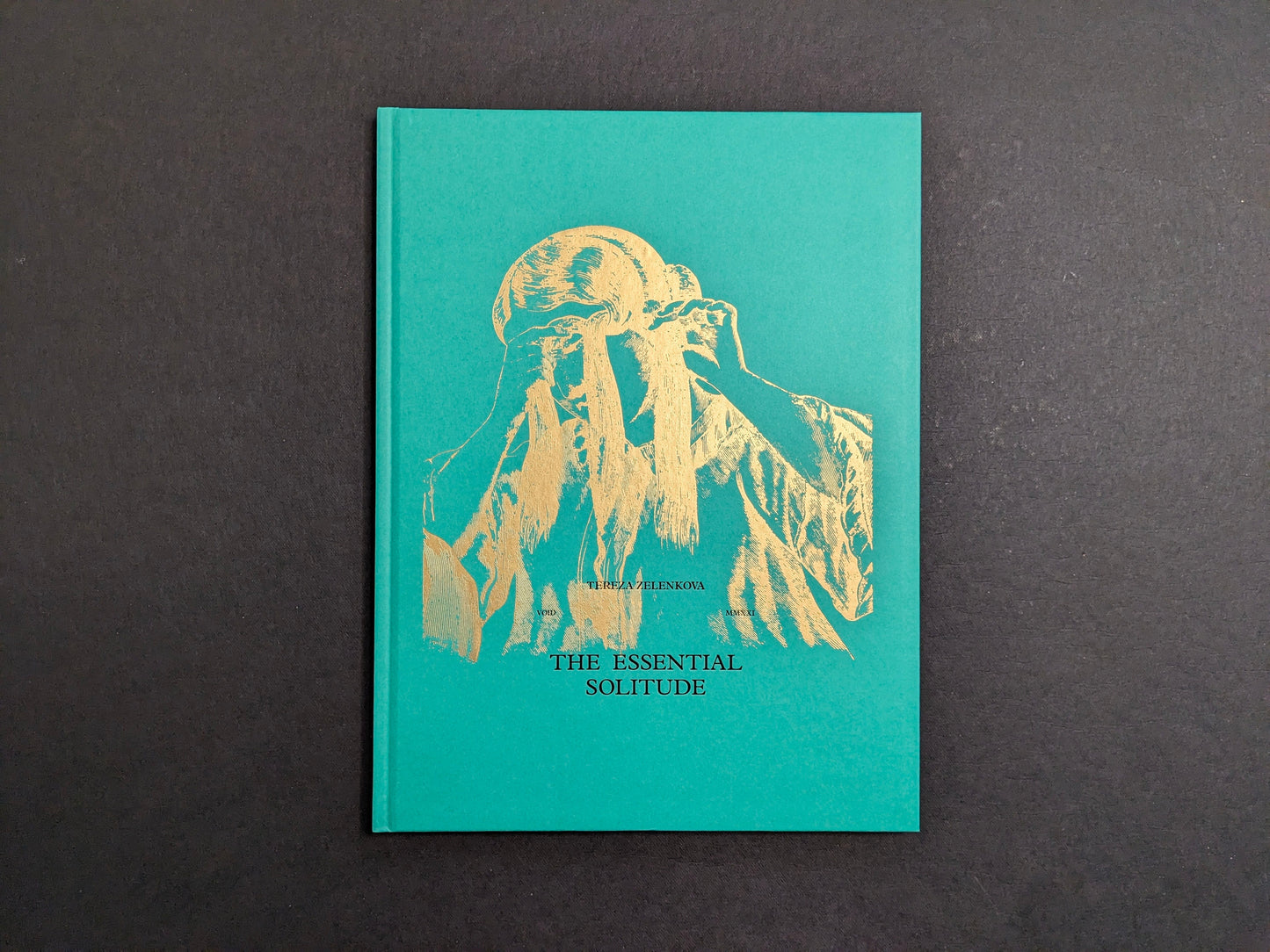 Green hardcover of The Essential Solitude by Tereza Zelenkova with gold illustration.