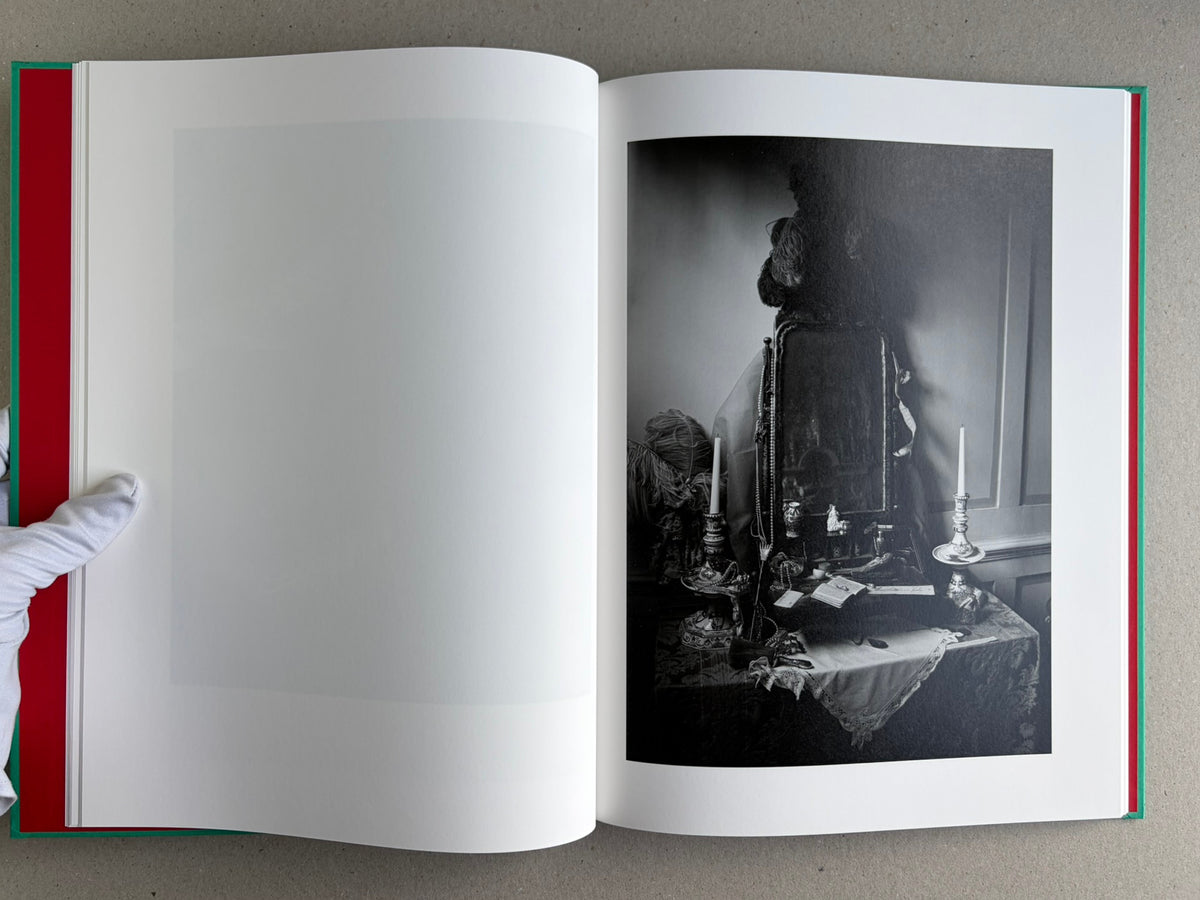Open spread from The Essential Solitude, with a black-and-white interior scene and a framed picture on the right page.
