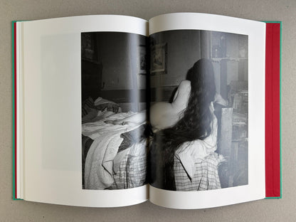 Open spread from The Essential Solitude, showing a black-and-white reclining figure in an interior on the right page.