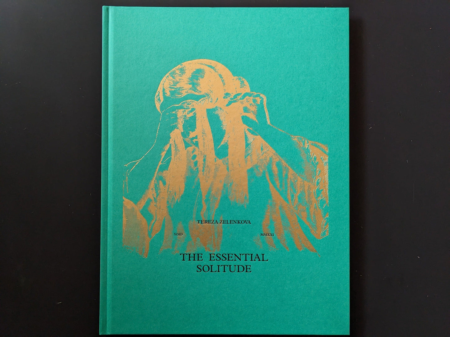 Front cover of The Essential Solitude with gold-foil figure on green cloth board.