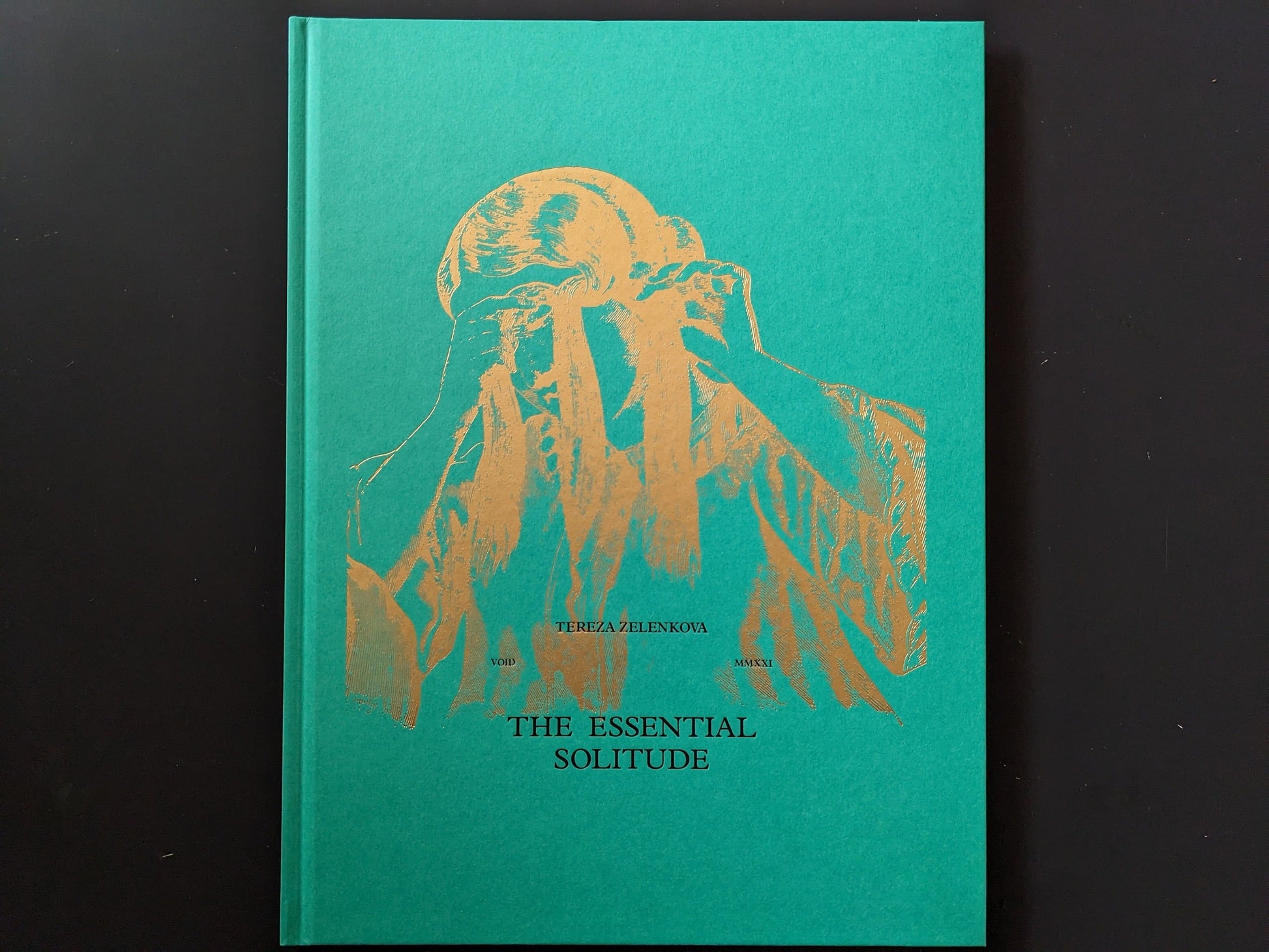 Front cover of The Essential Solitude with gold-foil figure on green cloth board.