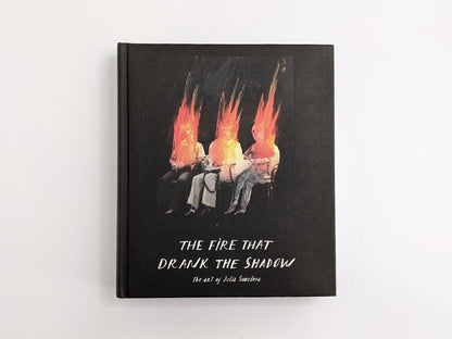 Front cover of The Fire That Drank The Shadow by Julia Soboleva, showing three seated figures with flame-like heads on a black cover.