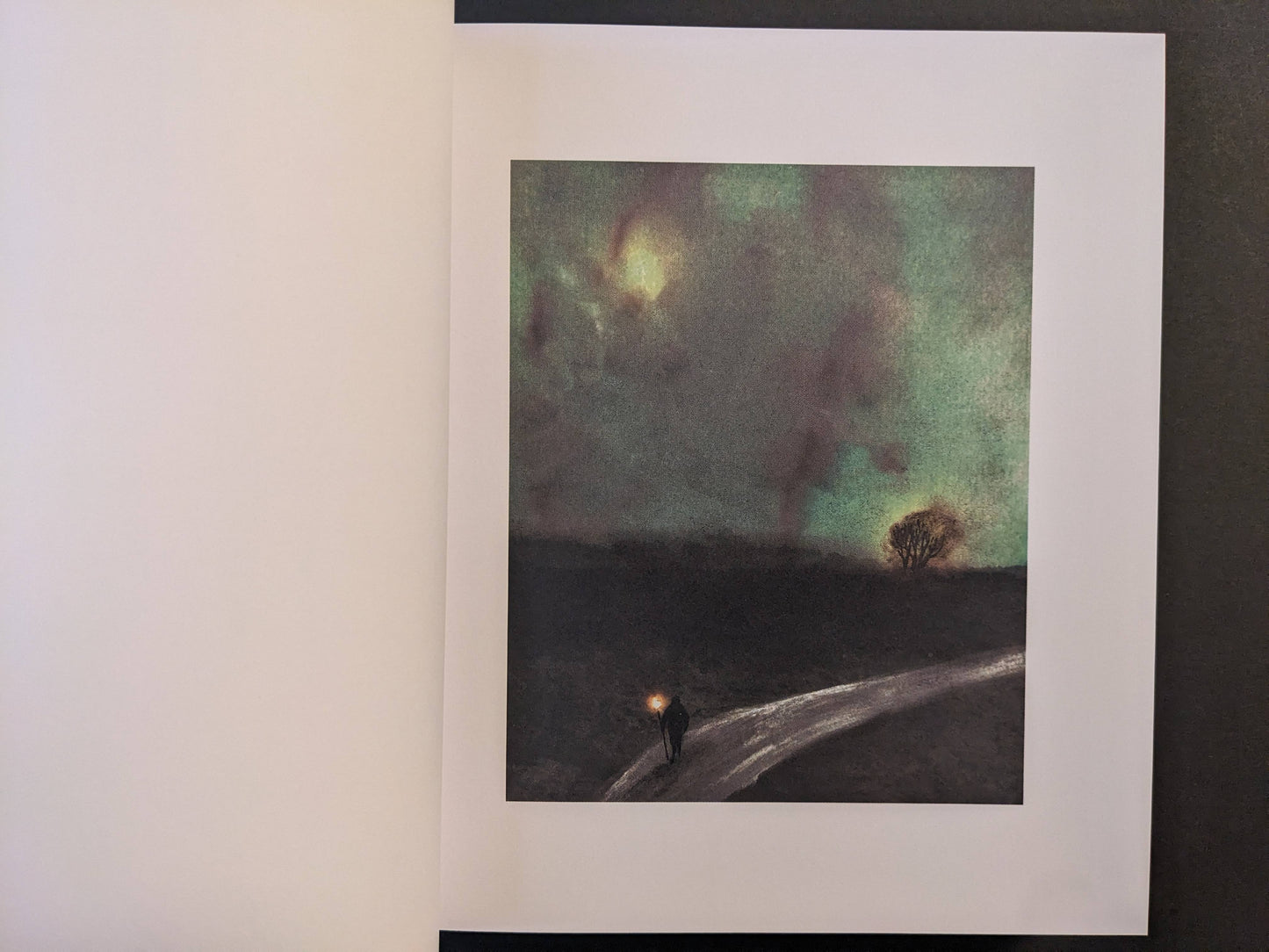 Interior page from The Fire That Drank The Shadow by Julia Soboleva, with a small figure carrying a light along a winding road under a green sky.