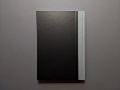 Back cover of 'The Last Slogan' – minimalist black with grey cloth spine