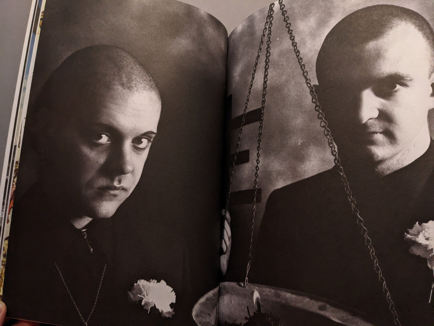 Black-and-white portrait of Genesis P-Orridge and Peter Christopherson with flowers.