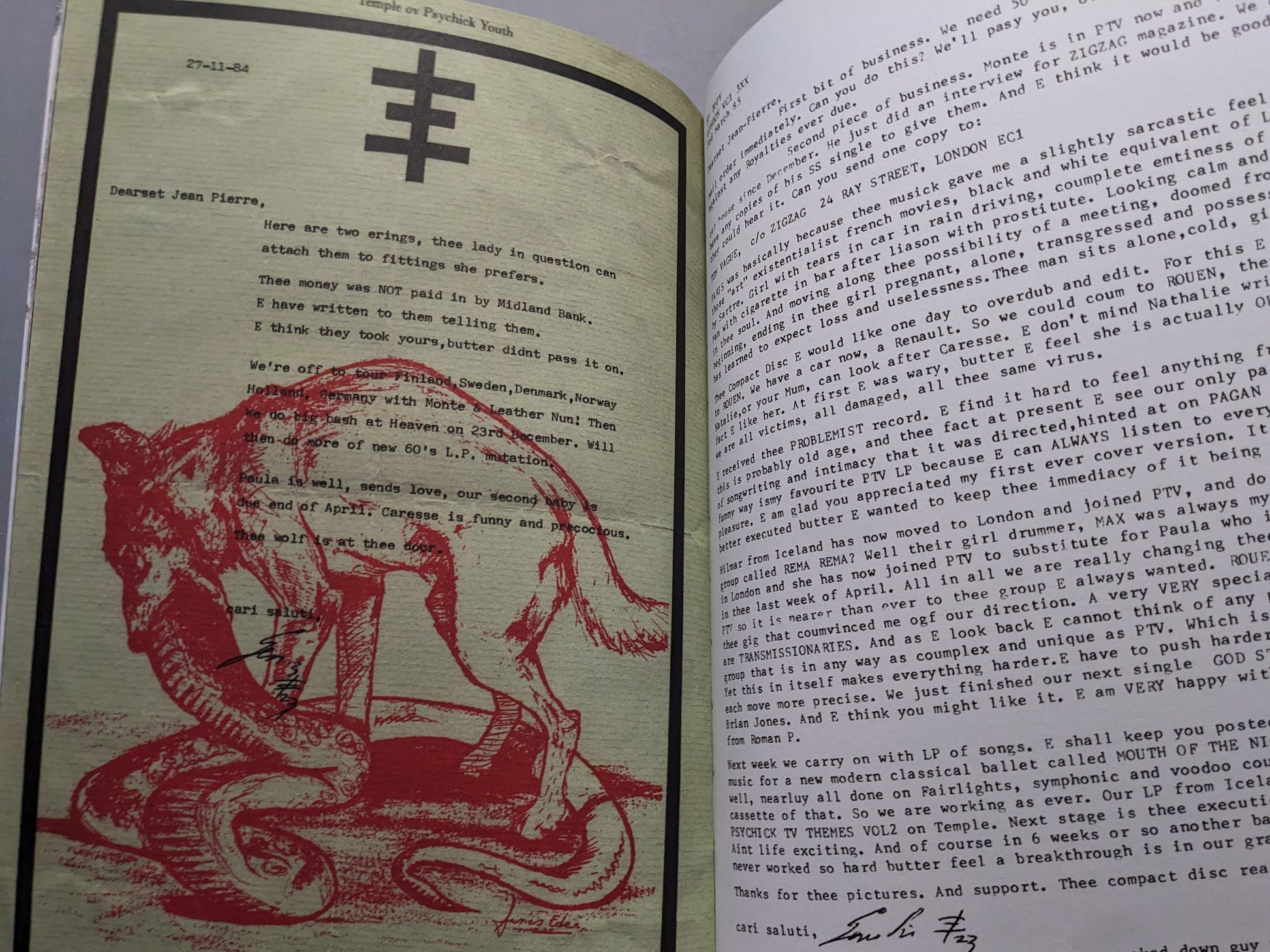 Interior page with a typewritten letter and red wolf and snake illustration.