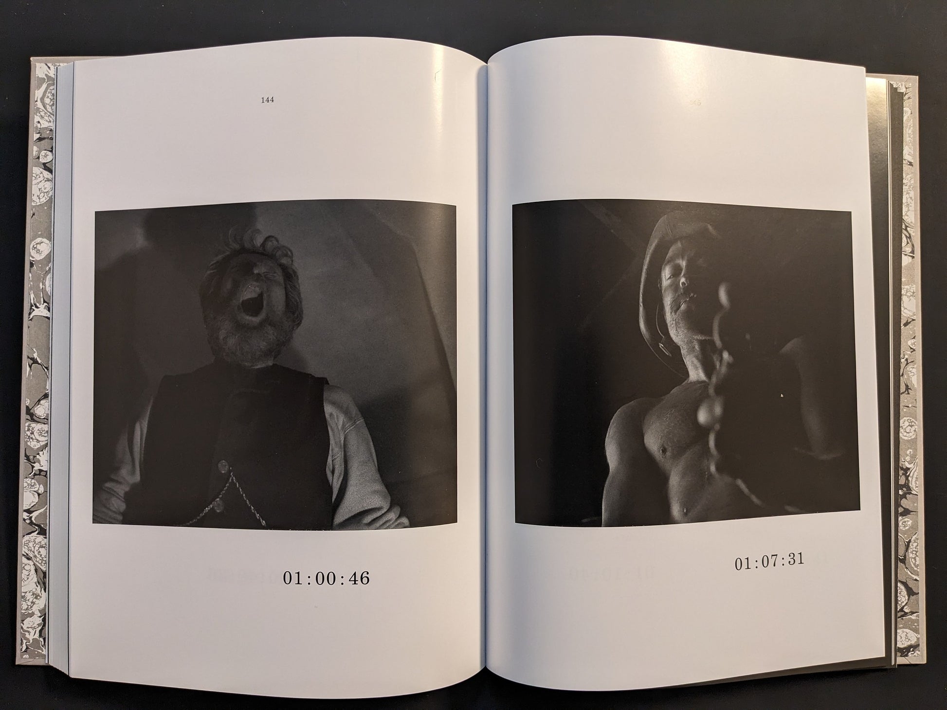 Double-page spread showing monochrome film frames from The Lighthouse in the screenplay book.