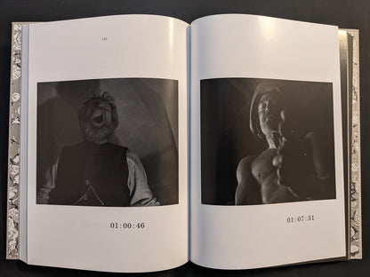 Double-page spread showing monochrome film frames from The Lighthouse in the screenplay book.
